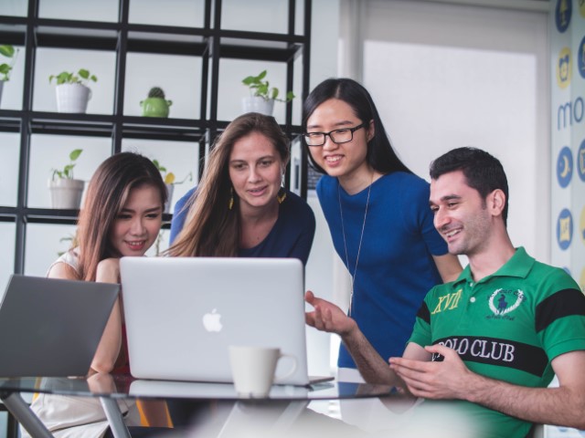 Students engaged in elearning in front of a computer